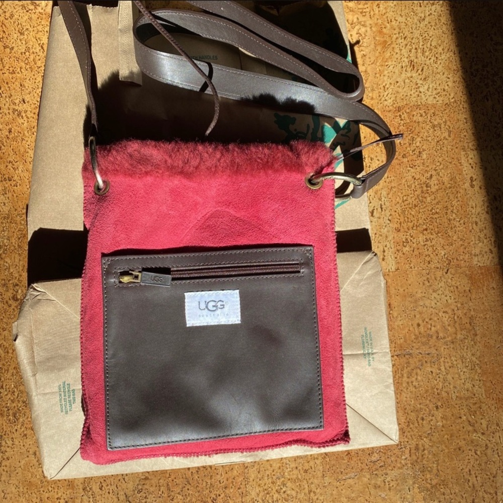 UGG cross body bag in red.  Like new, never used, lived in protective bag.
